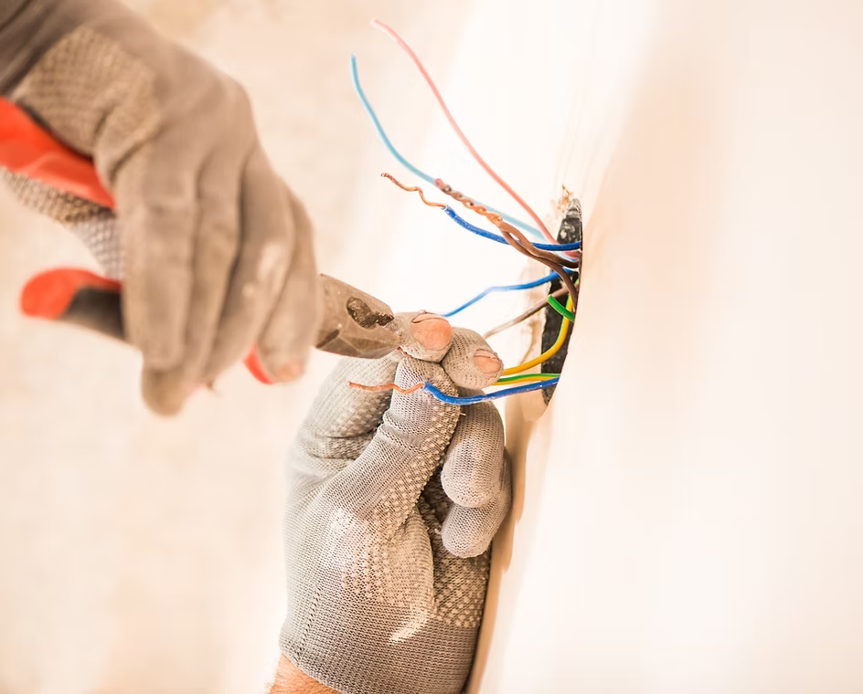 Close-up of an electrician wiring an outlet